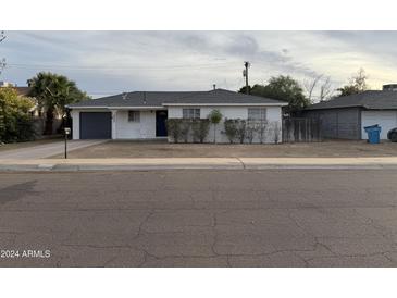 Charming single-story home with a welcoming front yard and attached garage at 2207 W State Ave, Phoenix, AZ 85021