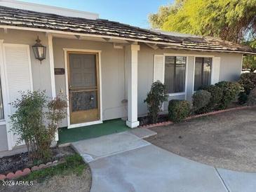 Front exterior of a single-story home with a covered entryway and landscaping at 5008 W New World Dr, Glendale, AZ 85302