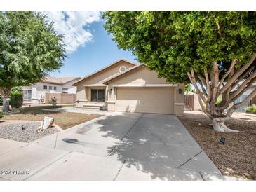 Charming single-story home with a two-car garage and landscaped front yard at 330 E Constitution Dr, Gilbert, AZ 85296