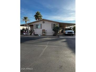 Single-story home with a carport and holiday decorations at 11596 W Sierra Dawn Blvd # 156, Surprise, AZ 85378