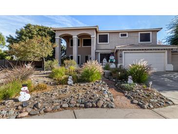 Two-story house with landscaped front yard and a three-car garage at 20171 N Bustos Way, Maricopa, AZ 85138