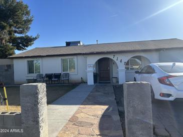 House exterior showcasing a ranch-style home with a well-maintained yard at 7147 W Westview Dr, Phoenix, AZ 85033