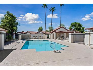 Community pool with patio and seating area at 1120 N Val Vista Dr # 77, Gilbert, AZ 85234