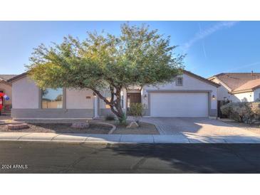 Single-story home with a two-car garage and landscaped front yard at 19776 N Harris N Dr, Maricopa, AZ 85138