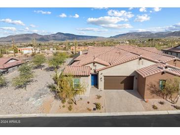 Single-story home with a tile roof and a two-car garage, mountain views at 38500 N School House Rd # 45, Cave Creek, AZ 85331