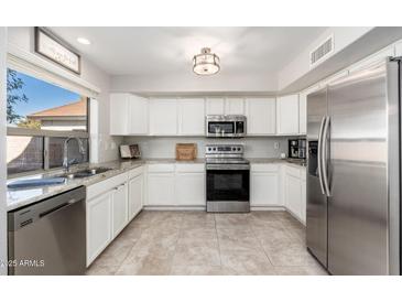 Modern kitchen with stainless steel appliances and granite countertops at 4660 E Torrey Pines Lane Ln, Chandler, AZ 85249