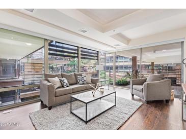Inviting living room with large windows, comfortable seating, and stylish decor at 7151 E Rancho Vista Dr # 4001, Scottsdale, AZ 85251