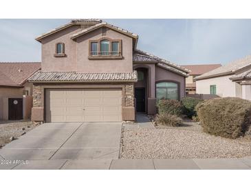 Two-story home with a two-car garage and desert landscaping at 5852 S 248Th Ln, Buckeye, AZ 85326