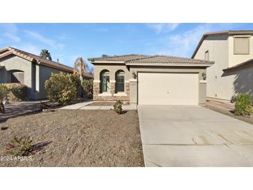 One-story home with a two-car garage and desert landscaping at 44792 W Miraflores St, Maricopa, AZ 85139