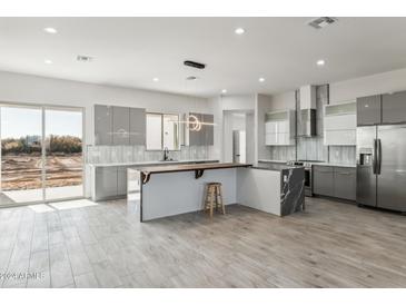 Spacious kitchen featuring modern appliances and a large island at 24825 W Western Star Blvd, Buckeye, AZ 85326