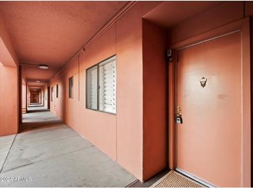 Exterior hallway leading to the front door of the unit at 4303 E Cactus Rd # 146B, Phoenix, AZ 85032
