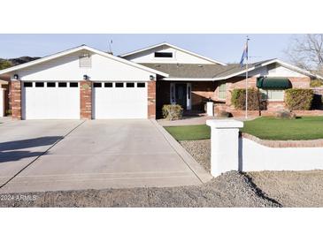 Charming two-story home with brick facade, two-car garage, and landscaped front yard at 4304 W Calle Poco --, Laveen, AZ 85339