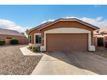 Single-story home with brown exterior and a two-car garage at 13727 W Marissa Dr, Litchfield Park, AZ 85340