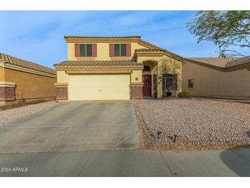 Two-story house with a large driveway and desert landscaping at 24018 W Wayland Dr, Buckeye, AZ 85326