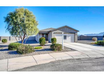 One-story house with a two-car garage, landscaping, and a gravel driveway at 638 E Hinton Rd, Eloy, AZ 85131