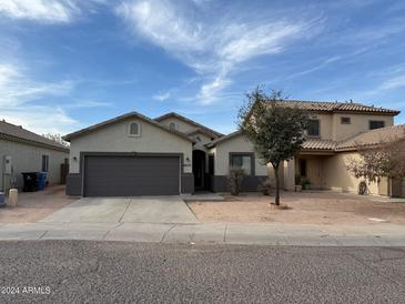 Single-story home with a two-car garage and front yard landscaping at 6630 S 10Th Dr, Phoenix, AZ 85041