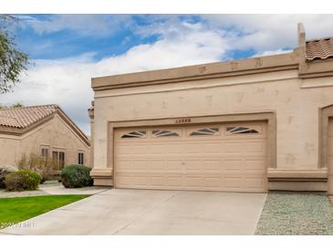 Attached garage with a double-door, providing ample parking and storage at 19522 N 84Th Ave, Peoria, AZ 85382