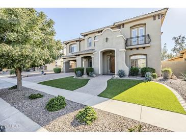 Two-story house with a landscaped front yard, attractive walkway, and a three-car garage at 4353 E Santa Fe Ct, Gilbert, AZ 85297