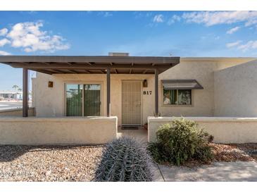 Front view of a single-story home with a covered porch at 817 E Lancaster Cir, Florence, AZ 85132