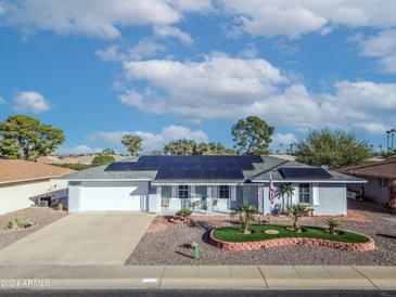 Single story home with solar panels and landscaped yard at 10754 W Brookside Dr, Sun City, AZ 85351