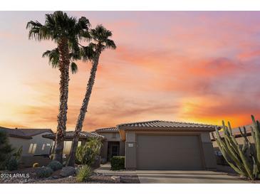 Desert landscape surrounds this single-story home with a two-car garage at 19330 N Hunters Run, Surprise, AZ 85387