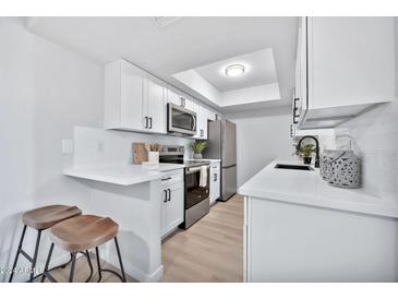 Updated kitchen featuring white shaker cabinets and stainless steel appliances at 4141 N 31St St # 414, Phoenix, AZ 85016