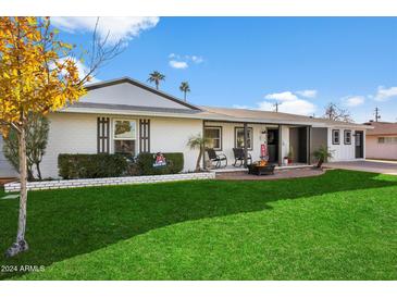 Beautiful ranch home with a well-manicured lawn and firepit at 4015 E Catalina Dr, Phoenix, AZ 85018