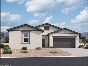 Single-story home with gray exterior, dark garage door, and landscaping at 47253 W Pecan Woods --, Maricopa, AZ 85139