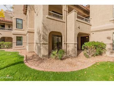 Ground level condo entry with private patio and lush landscaping at 9415 E Purdue Ave # 187, Scottsdale, AZ 85258