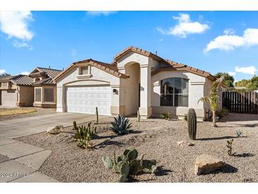 Charming one-story house with a two-car garage and attractive desert landscaping at 9550 E Plana Ave, Mesa, AZ 85212