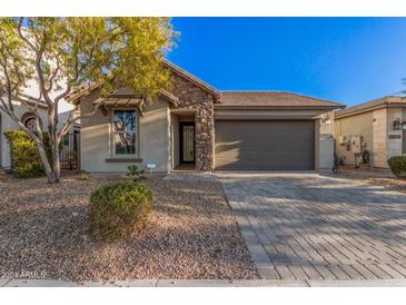 Single-story home with stone accents and a two-car garage at 28965 N 120Th Dr, Peoria, AZ 85383