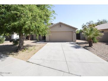 Single-story house with a two-car garage and a tree-lined driveway at 6709 W Luke Ave, Glendale, AZ 85303