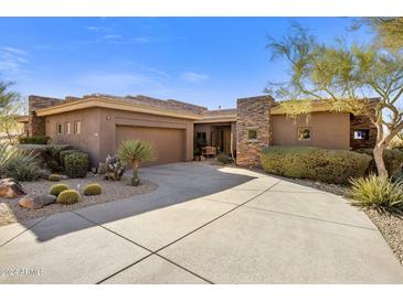 Single-story home with stone accents and desert landscaping at 10821 E Tusayan Trl, Scottsdale, AZ 85255