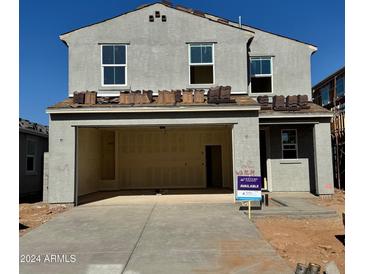 Two-story house with attached garage and neutral color palette at 17284 W Daley Ln, Surprise, AZ 85387