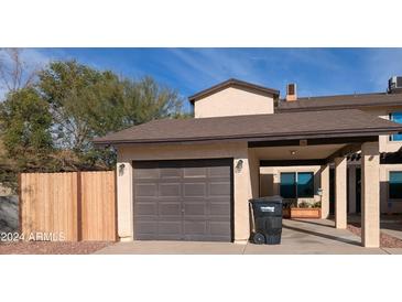 Attractive exterior of a two-story home with a carport and wooden fence at 306 E Ludlow Dr # A, Avondale, AZ 85323