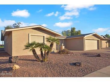 Tan one-story home with a two-car garage and desert landscaping at 4716 E Delta Ave, Mesa, AZ 85206