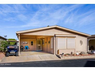 Tan single-wide manufactured home with carport and golf cart at 6097 S Pinehurst Dr, Chandler, AZ 85249