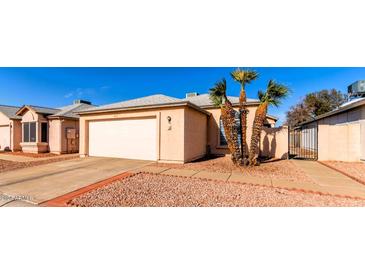 Front view of a single-story house with a garage and desert landscaping at 7318 W Greer Ave, Peoria, AZ 85345