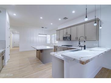 Modern kitchen with marble countertops and stainless steel appliances at 1270 E Baranca Rd, Gilbert, AZ 85297