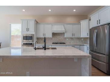 Spacious kitchen featuring modern appliances and a large island at 2029 W Tallgrass Trl, Phoenix, AZ 85085