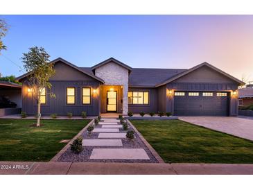 Two-story home with a welcoming front porch and landscaped lawn at 4127 E Cambridge Ave, Phoenix, AZ 85008