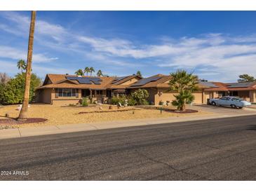 Single-story home with solar panels and desert landscaping at 13106 W Lyric Dr, Sun City West, AZ 85375