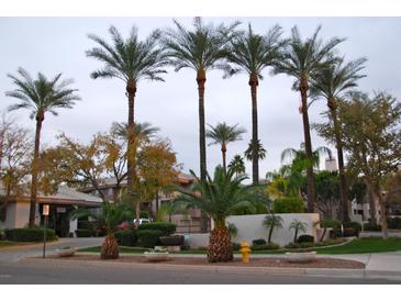 Attractive community entrance with lush landscaping and palm trees at 4343 N 21St St # 203, Phoenix, AZ 85016