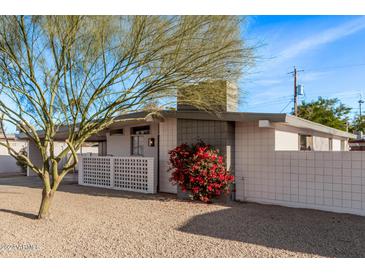 Mid-century modern home with a landscaped front yard and attractive curb appeal at 3801 W Golden Ln, Phoenix, AZ 85051