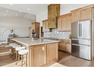 Gourmet kitchen boasts modern appliances and a large island at 11549 E Bella Vista Dr, Scottsdale, AZ 85259