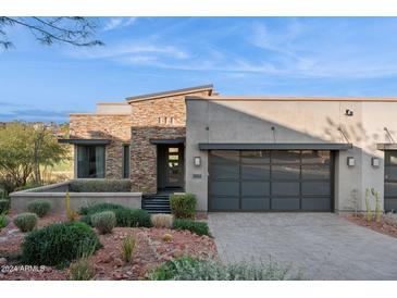 Modern home with stone accents and a two-car garage at 16064 E Ridgestone Dr, Fountain Hills, AZ 85268