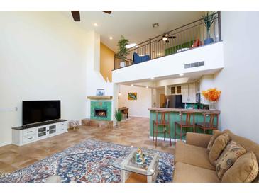 Open living room with high ceilings, fireplace, and loft area at 13022 N Mountainside Dr # B, Fountain Hills, AZ 85268