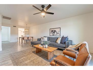 Bright living room with comfy seating and a modern coffee table at 13316 N 26Th Dr, Phoenix, AZ 85029