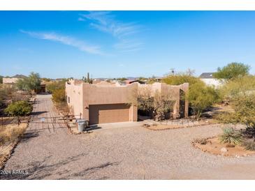 Single-story home with a two-car garage and desert landscaping at 38406 N 12Th Ave, Phoenix, AZ 85086