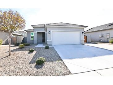 Single-story home with attached garage and desert landscaping at 18157 W Foothill Dr, Surprise, AZ 85387